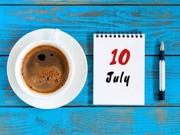 july 10 notepad next to a cup of coffee